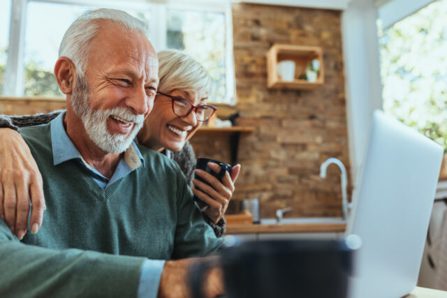 A couple is looking at how to design CX on the laptop.