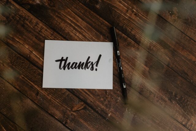One of the gift cards on the desk says thank you.
