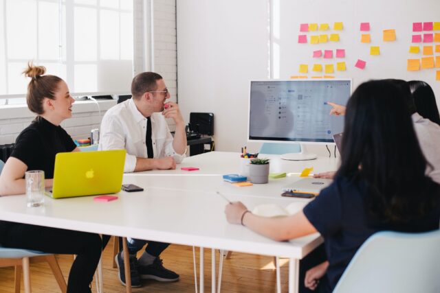 A group of people talking about how to improve employees' engagement