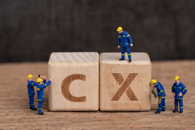 People work on two blocks representing the need for improvements in CX technology.