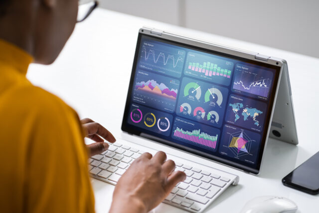an image showing a young women checking the behavioural analytics on her laptop.
