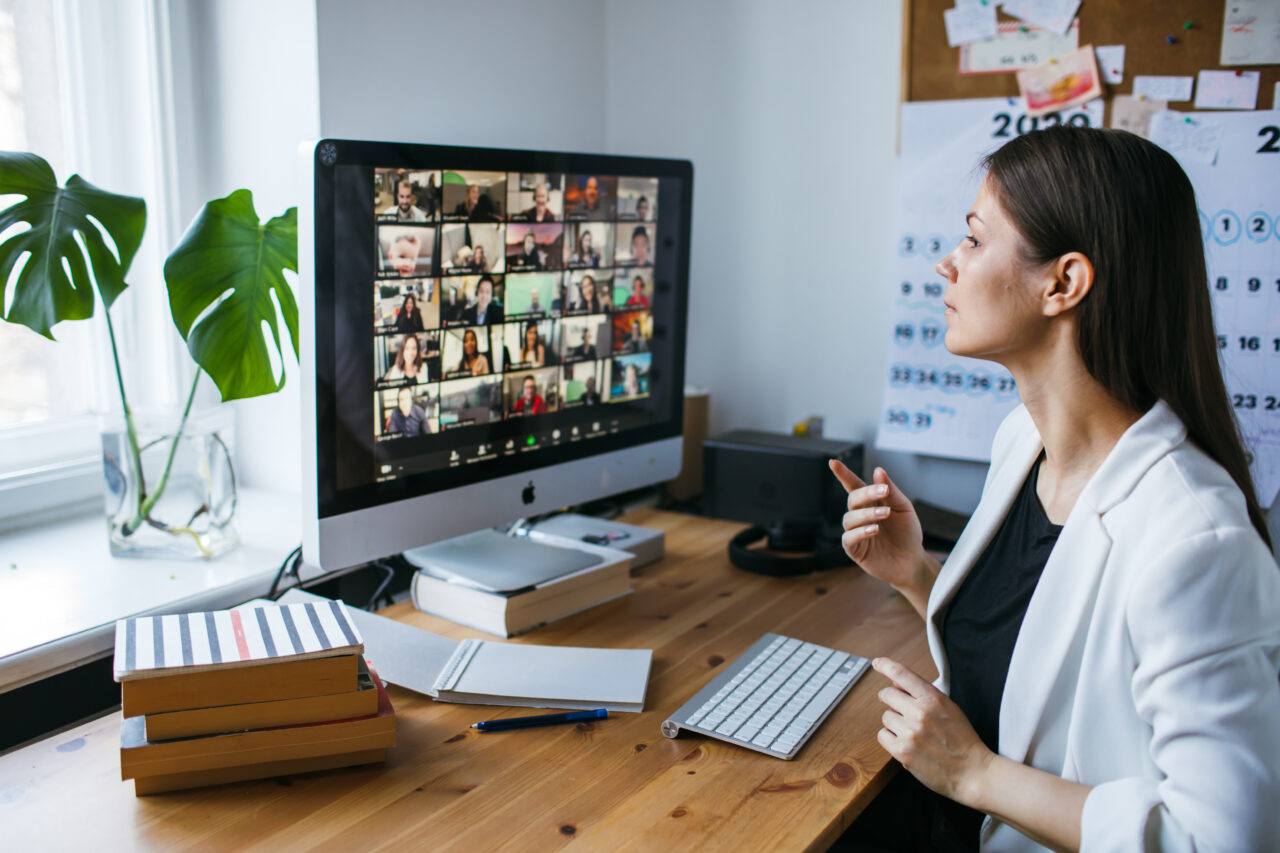 an image showing a young woman using the zoom app to talk to the customer support agents. 