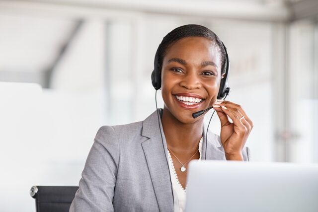 Customer service agent smiling.