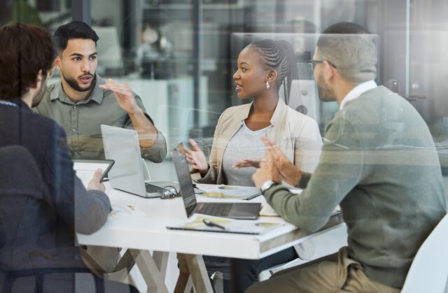 Employees in an office, working and talking.