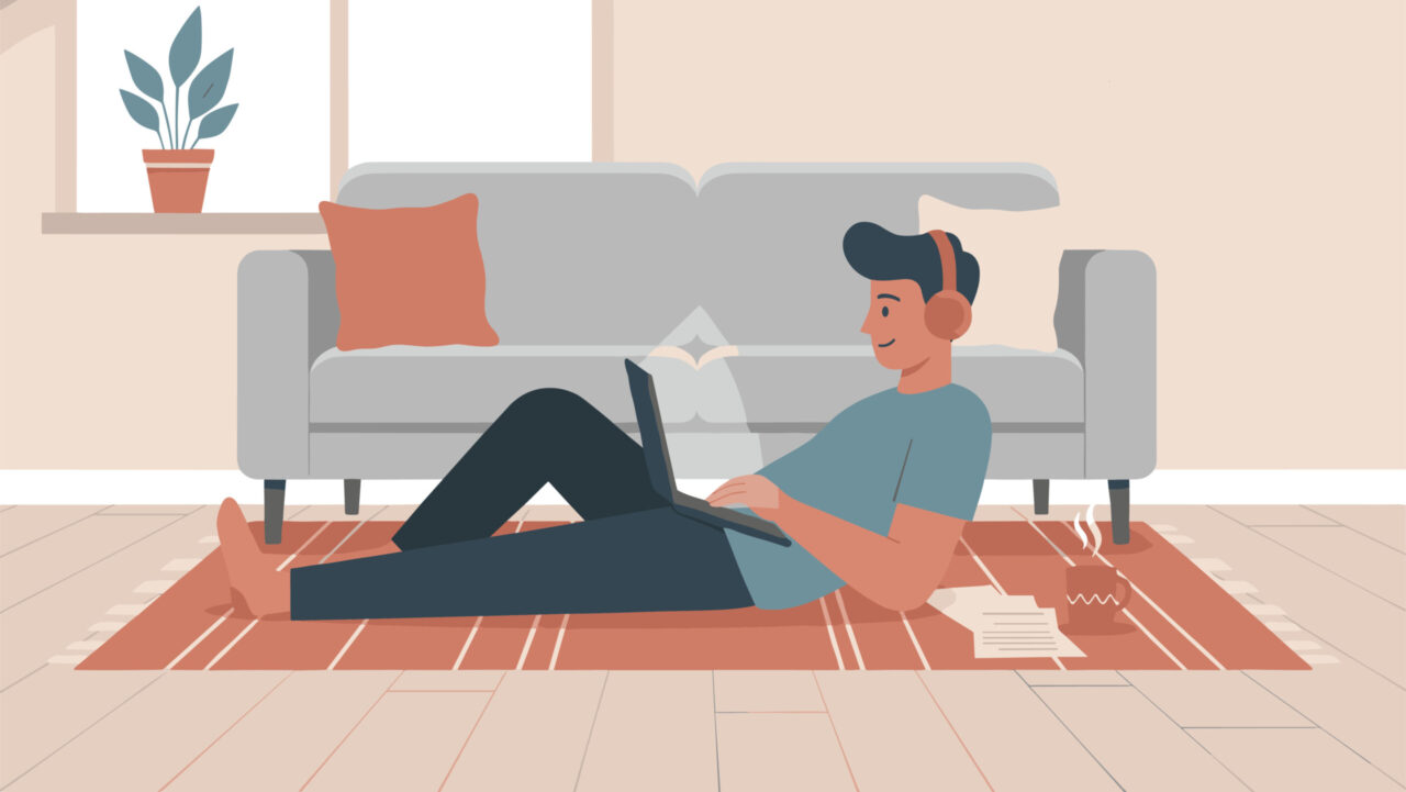 Young man relaxing on a living room rug while working, depicting workplace situationship